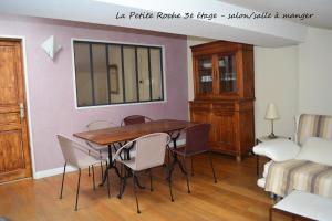 a dining room with a table and chairs and a bed at Petite Roche centre historique La Rochelle in La Rochelle +16 photos