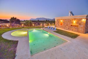 a swimming pool in the backyard of a house at Iridanos Villa in Kissamos