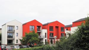 a row of red and white apartment buildings at Apartment Alleestraße in Büsum