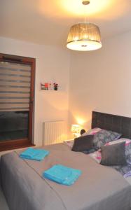 a bedroom with a bed with blue towels on it at Gdańsk-Apartament Jaglana Spa in Gdańsk +9 photos