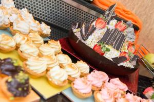 a bunch of cupcakes and cakes on a table at Atrium Hotel Thassos in Potos