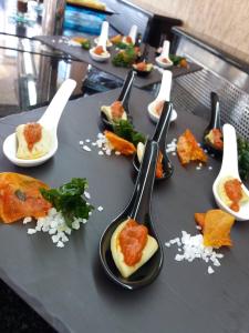 a group of spoons on a table with food at Atrium Hotel Thassos in Potos