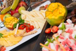 a display of cheese and other foods on a table at Atrium Hotel Thassos in Potos