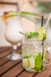 a mason jar filled with a drink with a lime at Atrium Hotel Thassos in Potos