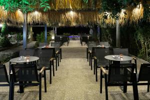 a row of tables and chairs in a restaurant at Atrium Hotel Thassos in Potos