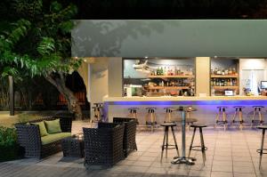 a bar with stools and a counter in a restaurant at Atrium Hotel Thassos in Potos