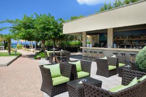 a patio with chairs and tables and a bar at Atrium Hotel Thassos in Potos