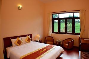 Postel nebo postele na pokoji v ubytování Ky Hoa Hotel Da Lat