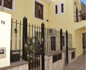 a black wrought iron fence in front of a house at El Relax in Salta
