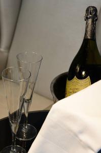 two empty wine glasses and a bottle of wine at Atrium Hotel Thassos in Potos