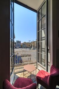 a view from a room with two chairs and a window at The Dante House by House In Naples in Naples