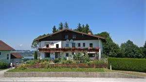 a white house with flowers in front of it at Haus Schmid Mattsee in Mattsee