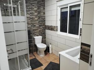 a bathroom with a toilet and a sink at Casa Faroleiro in Nazaré +44 photos
