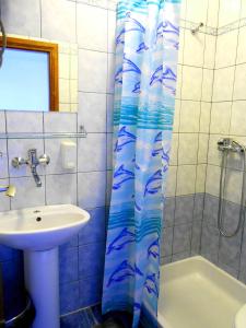 a bathroom with a sink and a shower curtain at Accommodation Susović in Lastovo +33 photos