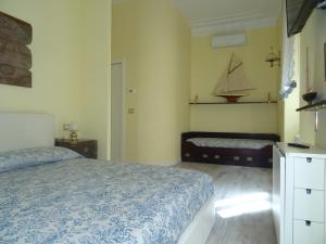 a bedroom with a bed and a boat on the wall at Suites Margot in Santa Margherita Ligure