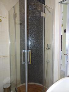 a shower with a glass door in a bathroom at Suites Margot in Santa Margherita Ligure