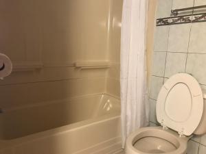 a bathroom with a toilet and a bath tub at Capri Motel in North Dartmouth