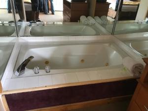 a bath tub with a faucet in a bathroom at Capri Motel in North Dartmouth