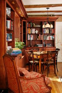 a dining room with a table and chairs and bookshelves at Sugar Hill Inn in Sugar Hill