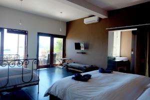 a bedroom with a bed with two towels on it at Blue Parrot in Labuan Bajo