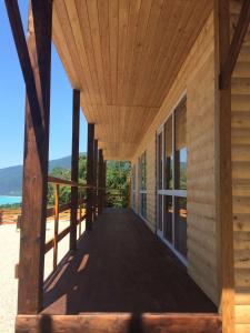 a wooden porch of a house with a view of the ocean at Guest House on Sovhoznaya in Gagra