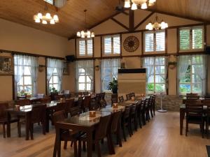 a restaurant with tables and chairs and a clock on the wall at Champs Yazuh B&B in Jiji