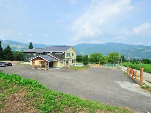 a large house with a parking lot in front of it at Lodge B&W in Minami Uonuma