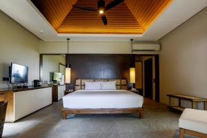 a bedroom with a bed and a ceiling fan at Amorita Resort in Panglao Island