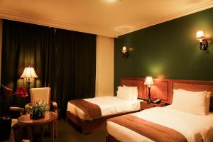 Ένα ή περισσότερα κρεβάτια σε δωμάτιο στο La Rosa Hotel By Brother International
