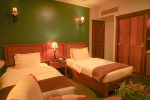 Ένα ή περισσότερα κρεβάτια σε δωμάτιο στο La Rosa Hotel By Brother International