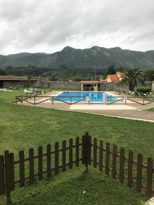 a fence in front of a yard with a pool at Hotel Palacio de Garaña in Garaña