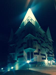 a building with a light on top of it at night at Apartment Triangle in Divčibare