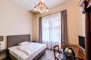 Säng eller sängar i ett rum på Hotel Villa Grunewald