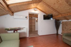 ein Wohnzimmer mit einer Decke mit Holzbalken in der Unterkunft Apartment Tre Rose in Zvoneće