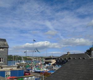 a marina with boats in the water and flags at Kinsale Centre Apartment in Kinsale