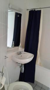 a bathroom with a sink and a toilet at Kinsale Centre Apartment in Kinsale