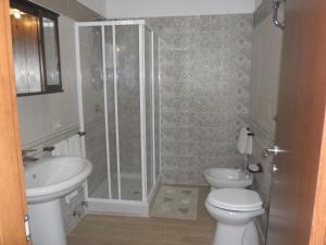 a bathroom with a shower and a toilet and a sink at La casa di Donato in Palinuro