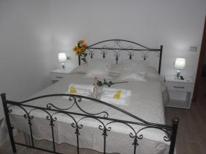 a bedroom with a large bed with two night stands at La casa di Donato in Palinuro