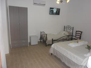 a bedroom with two beds and a dresser in it at La casa di Donato in Palinuro