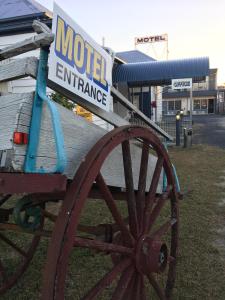 a horse drawn carriage parked on the side of a road at Monto Colonial Motor Inn in Monto