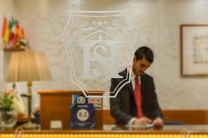 a man wearing a suit and a red tie at Hotel Silla in Rome
