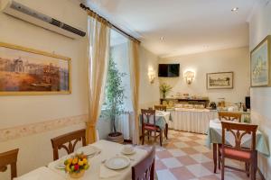 een restaurant met een tafel en stoelen en een keuken bij Hotel Silla in Rome