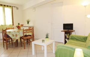 a living room with a table and a couch at La fontaine in Aiguèze