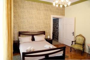 a bedroom with a bed with a stuffed animal on it at Casa Blanca in Sibiu