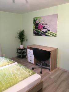 a bedroom with a desk and a bed at Apartment Royal Bavaria in Füssen