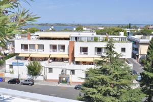 a white building with a street in front of it at Holiday Appartamenti in Grado