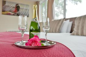 a bottle of champagne and two glasses on a table at Edenhall Country Hotel in Penrith