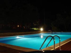 a swimming pool lit up at night with lights at Le querce felici in Montegabbione +16 photos
