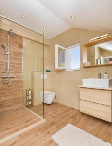 a bathroom with a glass shower and a sink at Apartments Marivo in Mlini +17 photos