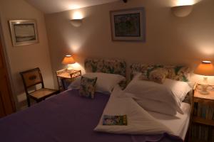 a bedroom with a bed and two pillows at The Barn @ Bishops Lydeard in Taunton